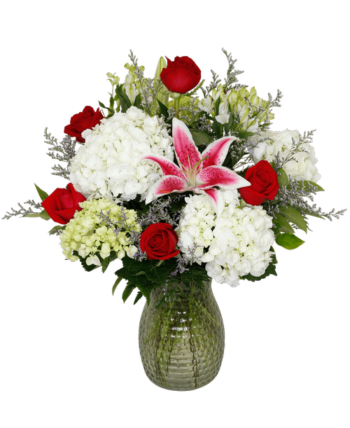 An impressive arrangement designed all around in a 10 inchH pebbled glass vase with six long stem red roses, hydrangea, mini green hydrangea, lilies, charmelia alstroemeria, and caspia. 24 inchH x 20 inchW