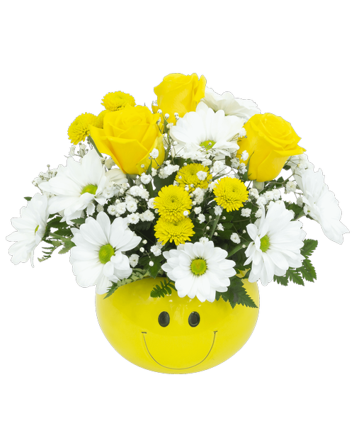 A cheery smiley face container holds an all-around arrangement with three roses, daisy poms, button poms, and baby's breath. 10.5 inchH x 12 inchW