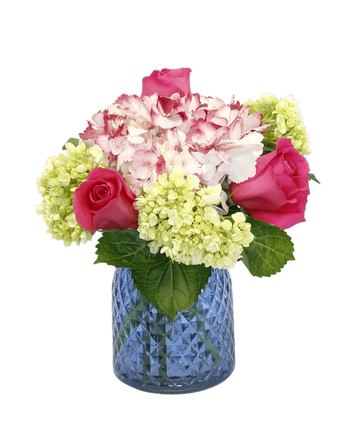 A 6.5 inchH glass vase with a diamond pattern holds three pink roses, a pink hydrangea, and three mini green hydrangea. 11 inchH x 11 inchW