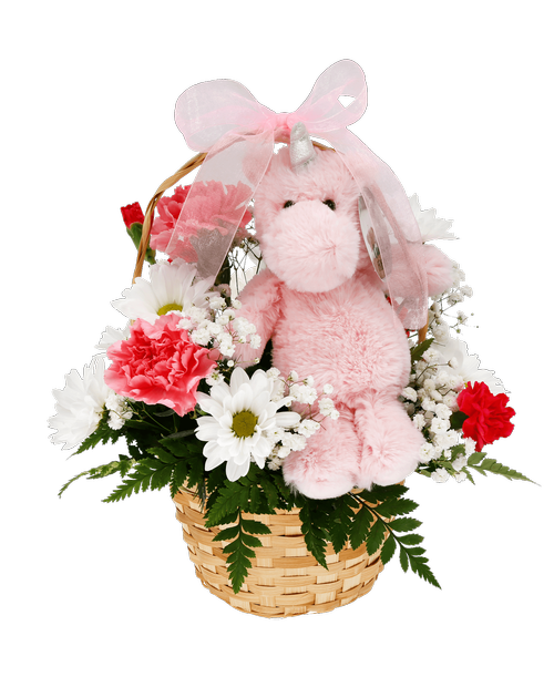 A 7 inch pink plush unicorn is surrounded by a 3/4 round arrangement in a basket with carnations, mini carnations, daisy poms, and baby's breath. 10 inchH x 10 inchW