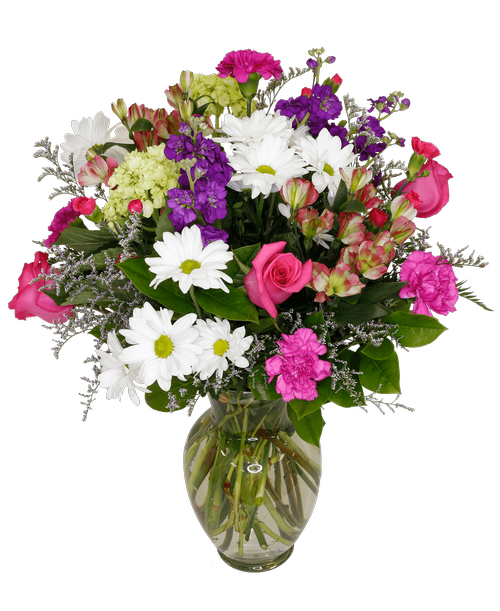A 10 inchH clear glass vase holds an all -around arrangement with three roses, stock, mini green hydrangea, charmelia alstroemeria, carnations, mini carnations, daisy poms, and caspia. 23 inchH x 15 inchW