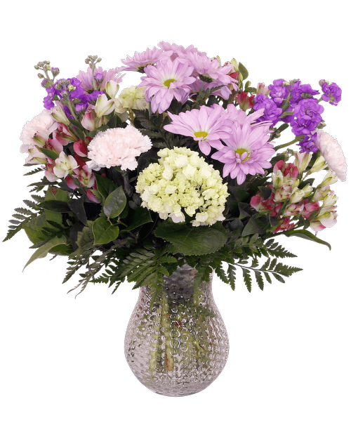 A 7 inch clear dimpled glass vase holds an all-around arrangement with mini green hydrangea, carnations, charmelia alstroemeria, daisy poms, and stock, 17.5 inchH x 14 inchW