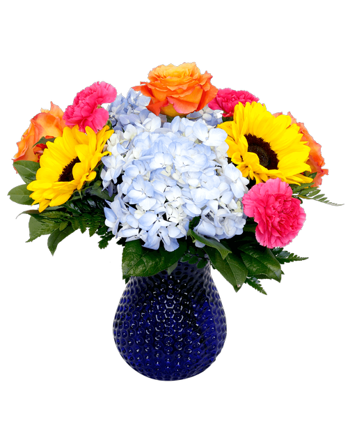 A 7 inch cobalt blue dimpled vase holds an all around arrangement with three roses, hydrangea, carnations, and two sunflowers. 15 inchH x 12 inchW