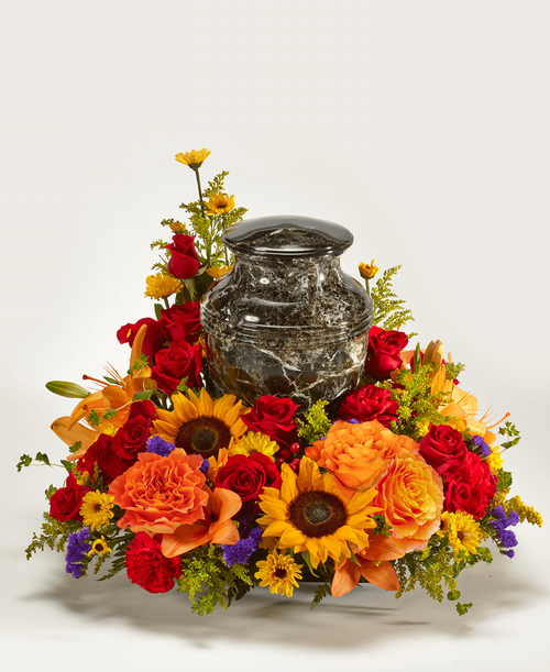 An all around arrangement from our Tuscan Funeral Collection, with roses, sunflowers, lilies, carnations, viking poms, hypericum, statice, and solidago. Suitable for a funeral or memorial service with the option to display a special memento, a framed photo, an urn, or a candle. 22 inchL x 21 inchW x 17 inchH 