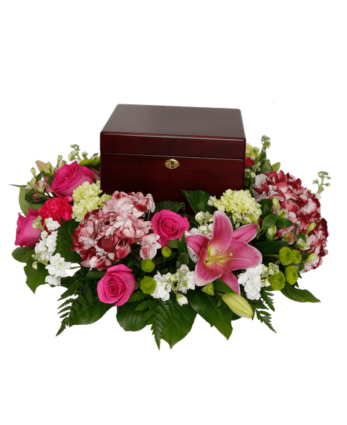 An all around arrangement from our Tender Thoughts Funeral Collection, with six roses, hydrangea, lilies, stock, mini green hydrangea, carnations, and button poms. Suitable for a funeral or memorial service with the option to display a special memento, a framed photo, an urn, or a candle. 7 inchH x 23 inchD (box not included)