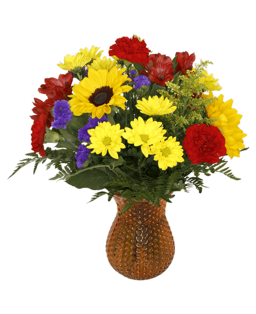 A 7 inch orange dimpled glass vase holds an all-around arrangement with sunflowers, carnations, mini carnations, alstroemeria, daisy poms, solidago, and statice. 18.5 inchH x 12 inchW