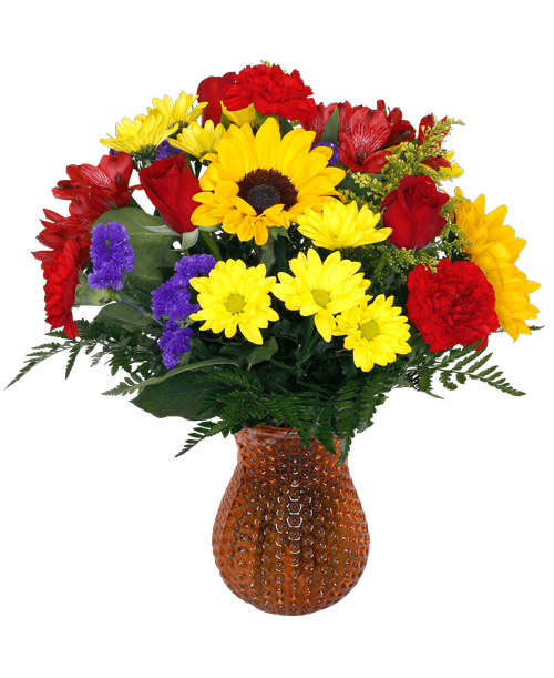 A 7.5 inch orange dimpled glass vase holds an all-around arrangement with three roses, sunflowers, carnations, mini carnations, alstroemeria, daisy poms, solidago, and statice. 18.5 inchH x 12 inchW
