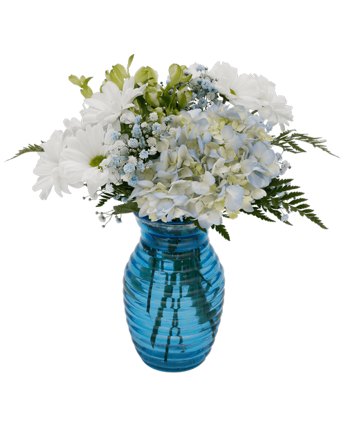 A 7.25 inchH blue glass vase with a horizontal design holds an all around arrangement with a hydrangea, charmelia alstroemeria, daisy poms, and blue dyed baby's breath. 13 inchH x 9 inchW