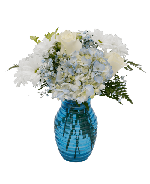 A 7.25 inchH blue glass vase with a horizontal design holds an all around arrangement with three roses, a hydrangea, charmelia alstroemeria, daisy poms, and blue dyed baby's breath. 13 inchH x 9 inchW