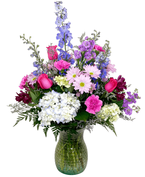 A 10 inch pebbled glass vase holds an all-around arrangement with three roses, hydrangea, delphinium, stock, alstroemeria, mini green hydrangea, daisy poms, carnations, and caspia. 32.5 inchH x 19 inchW