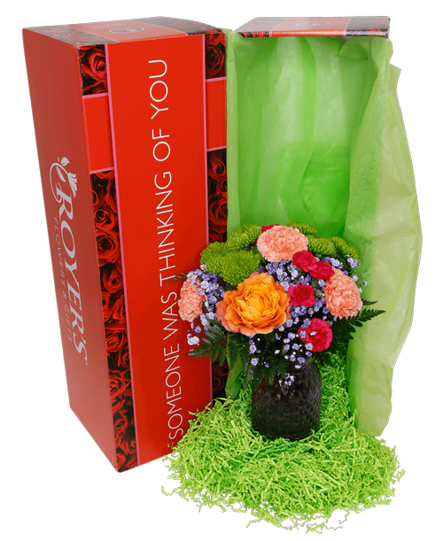 Hand-tied fresh flower bouquet with two orange free spirit roses, green cushions poms, orange carnations, hot pink mini carnations, and purple dyed babies breath. (6.5 inch lavender glass vase is included) 15 inchH x 12 inchW