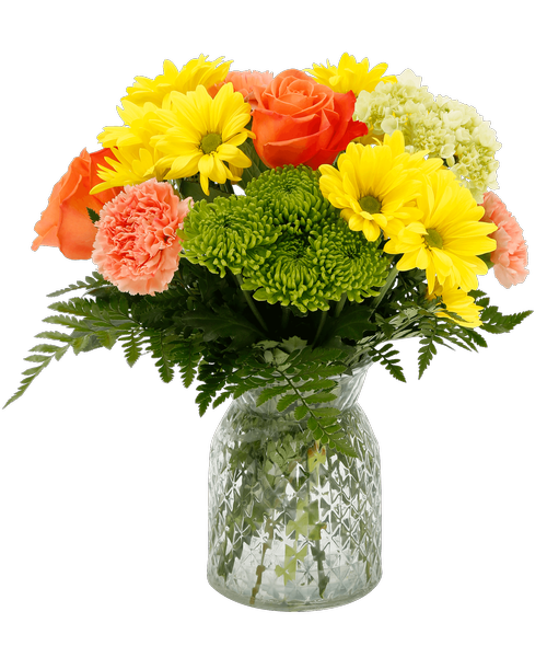 A 6.5 inchH clear glass vase with a diamond pattern holds an all-around arrangement with two orange roses, a mini green hydrangea, orange carnations, yellow daisy poms, and green button poms. 14 inchH x 11 inchW