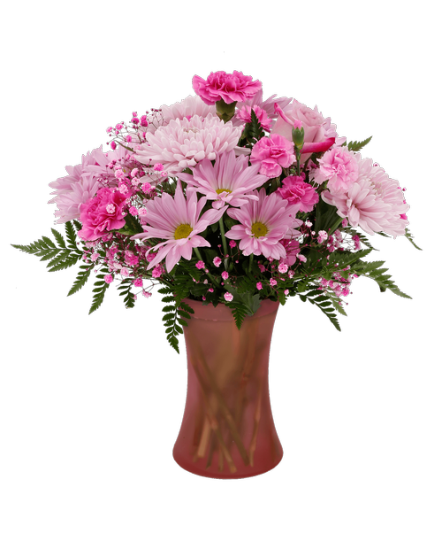 An 8 inch blush pink glass vase holds an all-around arrangement with a lavender rose, lavender carnations, lavender mini carnations, pink football mums, lavender daisy poms, and hot pink dyed baby's breath. 17 inchH x 14 inchW
