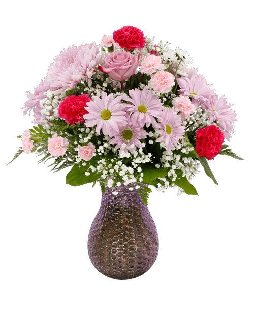 A 10 inch lavender dimpled glass vase holds an all-around arrangement with two lavender roses, hot pink carnations, pink mini carnations, lavender football mums, lavender daisy poms, yin yang poms, and baby's breath. 23 inchH x 19 inchW