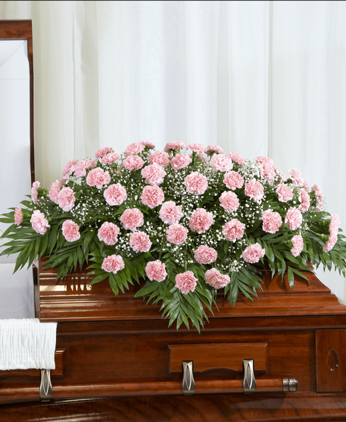 A half casket spray from our Traditional Funeral Collection designed with carnations and babies breath. 50 inchL x 40 inchW