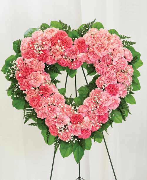 An 18 inch open heart from our Traditional Funeral Collection, suitable to be sent to a funeral or memorial service, is designed with carnations and babies breath. Displayed on a 54 inch Easel