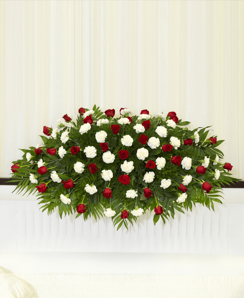 A full casket spray from our Classic Rose & Carnation Funeral Collection designed with roses and carnations. 60 inchL x 30 inchW