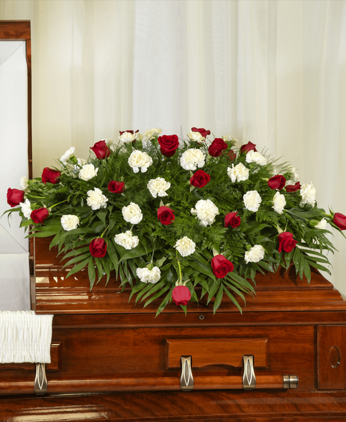 A half casket spray from our Classic Rose & Carnation Funeral Collection designed with roses and carnations. 46 inchL x 49 inchW