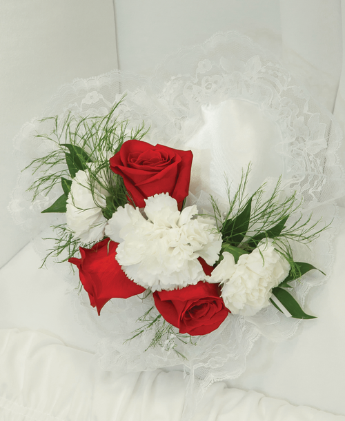 A 9 inch white pillow from our Classic Rose & Carnation Funeral Collection, suitable to be displayed at a funeral service inside the casket, is decorated with roses and carnations. Cluster 11 inchL x 5 inchW