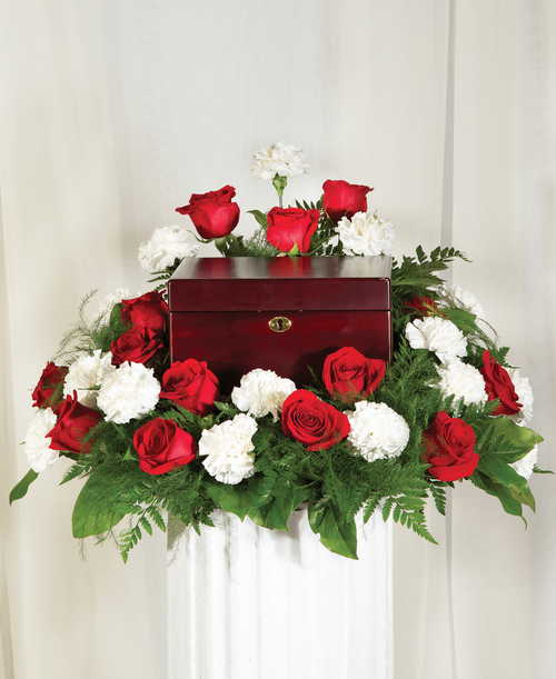 A memorial arrangement from our Classic Rose & Carnation Funeral Collection with roses and carnations. Suitable for a funeral or memorial service with the option to display an urn, photograph or a special memento. 15 inchH x 22 inchW