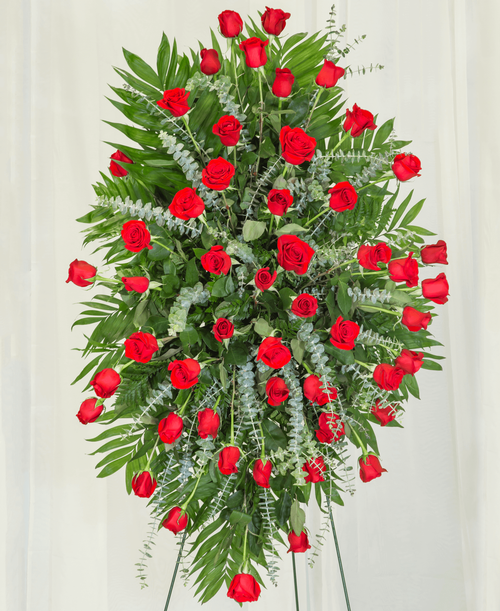 A standing spray from our Beloved Funeral Collection, suitable to be sent to a funeral or memorial service, designed with roses and assorted greens. 42 inchL x 30 inchW - Displayed on a 54 inch Easel.