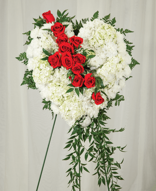 An 18 inch heart from our Beloved Funeral Collection, suitable to be sent to a funeral or memorial service, is designed with roses, hydrangea, carnations, and ruscus. Displayed on a 60 inch Easel; 38 inchL