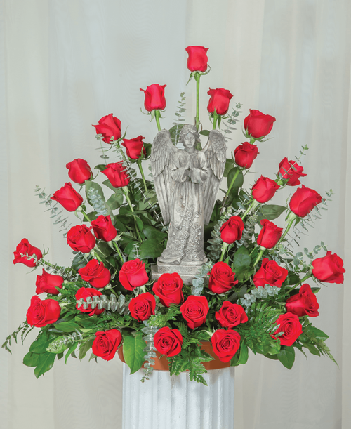 A one-sided arrangement from our Beloved Funeral Collection, suitable to be sent to a funeral or memorial service, featuring a 15 inch Angel surrounded by roses and assorted greens. 29 inchH x 30 inchW