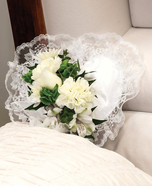 A 9 inch white pillow from our Celestial Funeral Collection, suitable to be displayed at a funeral service inside the casket, is decorated with a rose, carnations, alstroemeria, cushion poms, bells of Ireland and greens. 10 inchL x 4 inchW
