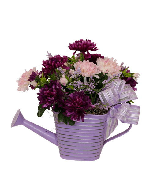 A 5 inch lavender ribbed watering can holds an all around silk arrangement in shades of purples, and a lilac bow. 10.75 inchH x 11.5 inchW