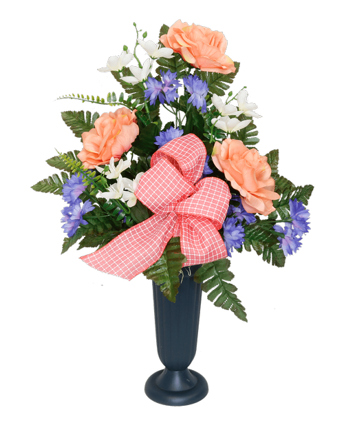 A plastic cemetery cup holds a one-sided silk arrangement with peach roses, blue cornflowers, white mini flowers, and a coral and white bow. 22.5 inchH x 16.5 inchW