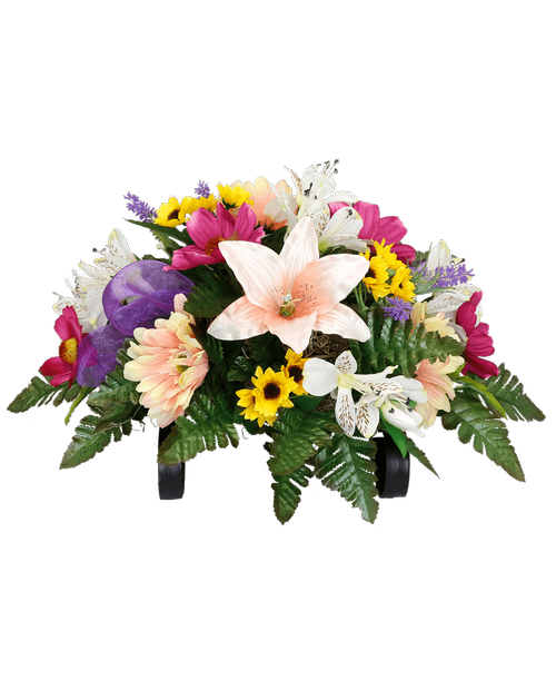 A cemetery gravestone saddle holds a silk arrangement with peach gerbera, peach lilies, white alstroemeria, orchid cosmos, mini sunflowers, lavender, and two purple sheer bows. 11 inchH x 19 inchW x 15 inchD