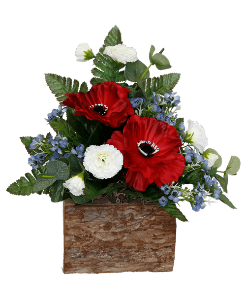 A 6 inch log box holds a one-sided silk arrangement with red, white, and blue flowers including poppies, mini carnations, and waxflower. 13 inchH x 13 inchW x 8 inchD
