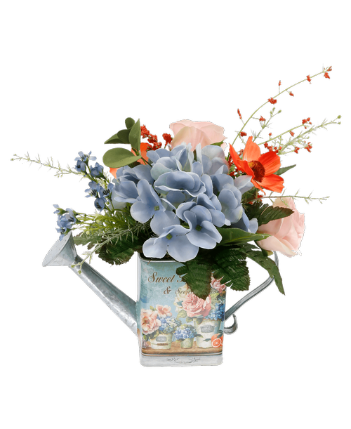 A 6 inch blue metal watering can and a garden design and saying 'Sweet Home & Secret Garden inch holds an all around silk arrangement with a blue hydrangea, pink roses, coral cosmos, and blue waxflower. 11 inchH x 11.5 inchW