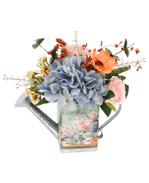 A 6 inch green metal watering can and a garden design and saying 'Sweet Home & Secret Garden inch holds an all around silk arrangement with a blue hydrangea, pink roses, coral cosmos, and yellow waxflower. 11 inchH x 11.5 inchW