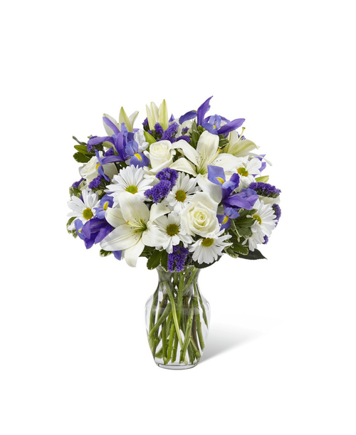 The Sincere Respect™ Bouquet is a soft and lovely way to express your condolences for your special recipient's loss. Blending together white roses, white traditional daisies, and white Asiatic Lilies with pops of blue iris and purple statice, this gorgeous bouquet is set to offer wishes of peace and caring kindness during this time of grief and loss. Presented in a classic clear glass vase, this fresh flower arrangement is a wonderful way to commemorate a life well lived. 19 inchHx15 inchW