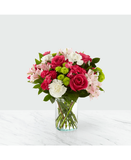 The true beauty of this bouquet is within the sweet colors of the flowers. An array of hot pink roses, pale pink alstroemeria and more are set in a glass cylinder vase, making a wonderful gift to light up the face of its recipient. 15 inchHx15 inchW