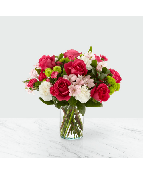 The true beauty of this bouquet is within the sweet colors of the flowers. An array of hot pink roses, pale pink alstroemeria and more are set in a glass cylinder vase, making a wonderful gift to light up the face of its recipient. 16 inchHx16 inchW