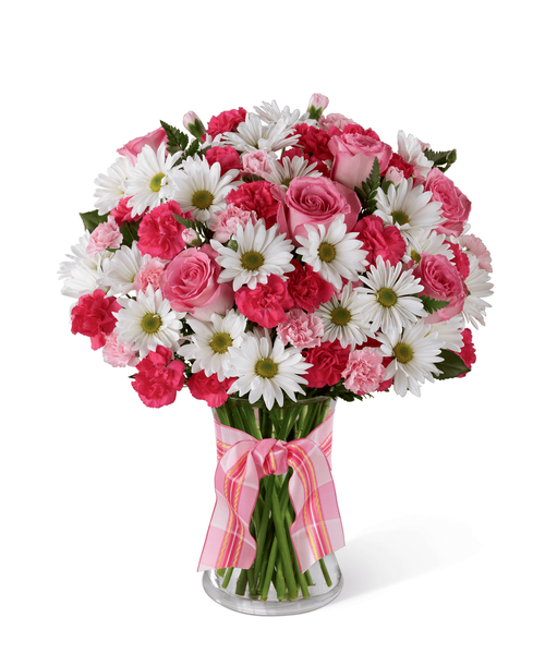 The FTD Sweet Surprises Bouquet is an absolutely charming way to send your warmest sentiments. Deep fuchsia and pink mini carnations, white traditional daisies and lush greens are sweetly situated in a classic clear glass vase accented with a perfectly pink designer ribbon to create a bouquet that will delight your special recipient at every turn. 15”H x 12”W.