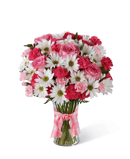 The FTD Sweet Surprises Bouquet is an absolutely charming way to send your warmest sentiments. Deep fuchsia and pink mini carnations, white traditional daisies and lush greens are sweetly situated in a classic clear glass vase accented with a perfectly pink designer ribbon to create a bouquet that will delight your special recipient at every turn. 16”H x 13”W.