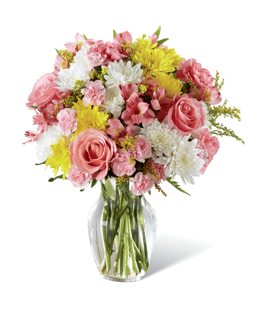 Beckoning with sunlit grace and beauty, this warm and uplifting bouquet is ready to offer cheer and flowering elegance to your recipient today. A collection of pink blooms, including Peruvian Lilies, carnations, mini carnations, and roses, are highlighted by yellow and white chrysanthemums, yellow solidago, and lush greens for a winning affect they will adore. Presented in a classic clear glass vase, this lovely bouquet is set to create a wonderful birthday, thank you, or get well gift! Approx. 16 inchH x 12 inchW.