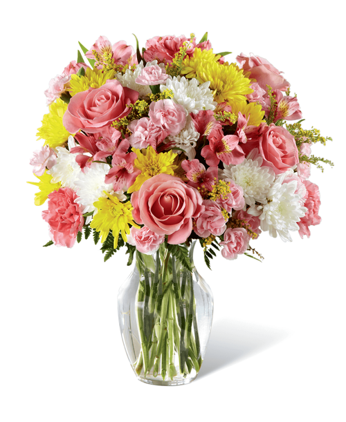 Beckoning with sunlit grace and beauty, this warm and uplifting bouquet is ready to offer cheer and flowering elegance to your recipient today. A collection of pink blooms, including Peruvian Lilies, carnations, mini carnations, and roses, are highlighted by yellow and white chrysanthemums, yellow solidago, and lush greens for a winning affect they will adore. Presented in a classic clear glass vase, this lovely bouquet is set to create a wonderful birthday, thank you, or get well gift! Approx. 17 inchH x 13 inchW.