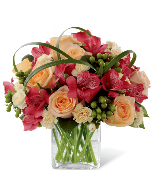 FTD proudly presents the Better Homes & Gardens All Aglow Bouquet. Light up their life with incredible color and blooming beauty when you send this exquisite flower bouquet. Unforgettable peach roses are surrounded by red Peruvian lilies, pale yellow mini carnations, green hypericum berries, lily grass blades and lush greens to create a stunning flower arrangement. Presented in a clear glass cube vase to give it a sophisticated look, this mixed flower bouquet will express your sweetest thank you, get well or congratulations wishes. 11 inchW x 10 inchH