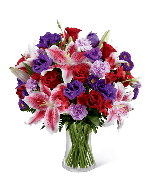 The FTD Stunning Beauty Bouquet is an absolutely lovely way to send your love and affection across the miles. Fragrant Stargazer lilies stretch their star-like petals across a bed of rich red roses, lavender carnations, red Peruvian lilies, purple double lisianthus, purple matsumoto asters and lush greens. Presented in a classic clear glass vase, this elegant bouquet is an incredible way to convey your sweetest sentiments. 18 inchW x20 inchH