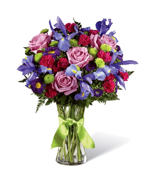 Share a world blooming in brilliant color and undeniable texture with this frilly and fun fresh flower bouquet . Blue iris, burgundy mini carnations, green button poms, lavender carnations, purple matsumoto asters, lavender roses, and lush greens mingle together to create a fascinating display. Presented in a modern clear glass vase tied with a lime green satin ribbon at the neck, this gift of flowers is a special surprise your recipient will love. Approx. 18 inchH x 13 inchW.