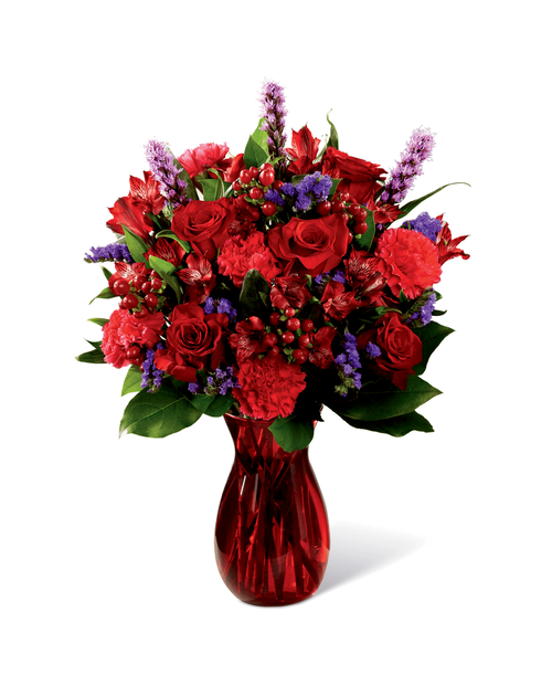 Love makes the world go round and this fresh flower arrangement is out to prove it with it's deep, romantic coloring and, oh, so sophisticated styling. Rich red roses mingle with red Peruvian Lilies, hot pink carnations, purple statice, red hypericum berries, liatris, and lush greens, elegantly arranged in ruby red glass vase to create an impactive visual affect. Bursting with love from every bloom, this bouquet is out to create a standout anniversary, birthday, or, I love you gift. Approx. 20 inchH x 14 inchW.