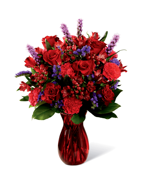 Love makes the world go round and this fresh flower arrangement is out to prove it with it's deep, romantic coloring and, oh, so sophisticated styling. Rich red roses mingle with red Peruvian Lilies, hot pink carnations, purple statice, red hypericum berries, liatris, and lush greens, elegantly arranged in ruby red glass vase to create an impactive visual affect. Bursting with love from every bloom, this bouquet is out to create a standout anniversary, birthday, or, I love you gift. Approx. 21 inchH x 15 inchW.