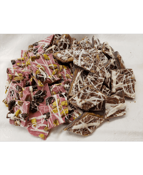 Half pound Ruby Bark - fruity, tart, and smooth with pistachios and raisins; and Triple Salted Caramel Bark - Dark, Milk, and White Chocolate ribboned with Salted Caramel.