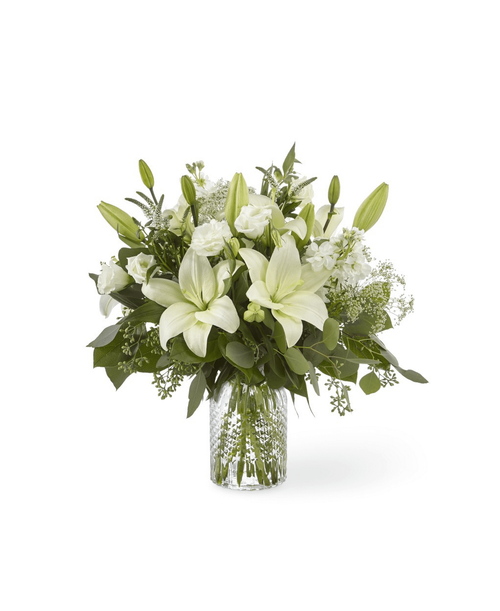 Our Alluring Elegance Bouquet is a striking array of ivory and green. Handcrafted using Asiatic lilies interwoven with white Veronica, white stock, Queen Anne's lace, silver dollar eucalyptus and seeded eucalyptus, this bouquet graces every room with a touch of elegance. 18 inchHx17 inchW