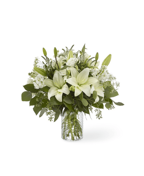 Our Alluring Elegance Bouquet is a striking array of ivory and green. Handcrafted using Asiatic lilies interwoven with white Veronica, white stock, Queen Anne's lace, silver dollar eucalyptus and seeded eucalyptus, this bouquet graces every room with a touch of elegance. 19 inchHx18 inchW