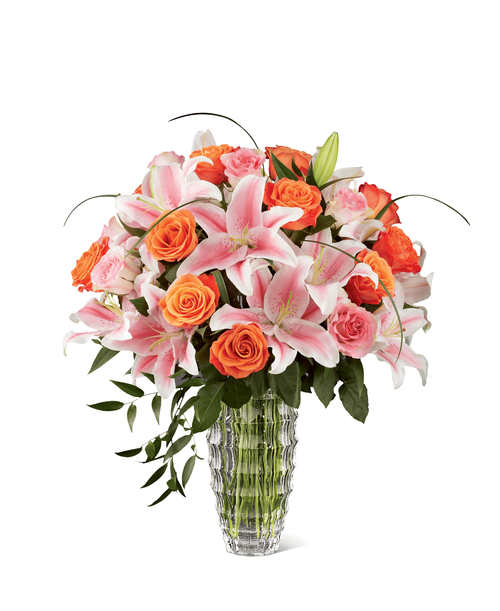 Simply grand in color and style, this artisan design brings together a favorite color combination of orange against pink and succeeded in making it both modern and sophisticated. A celebration of life, love, and every wonderful moment along the way, this bright and showy arrangement exhibits a soft fragrance from it’s blooms while sitting in a clear glass vase with a modern flair that adds further interest and style to its overall look. When you send this bouquet you send happiness. Approx. 25 inchH x 20 inchW